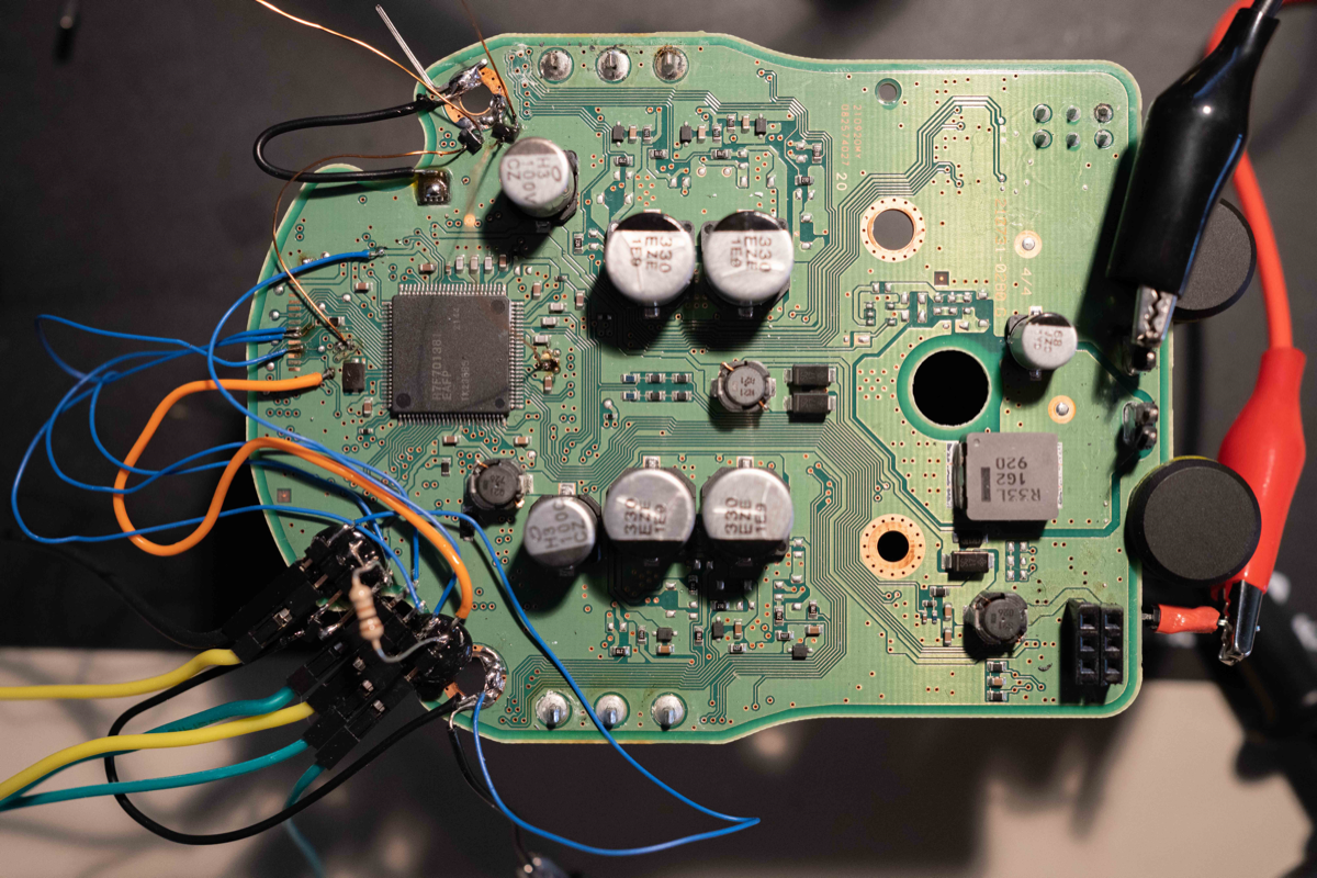 The RH850/P1M-E ECU PCB from a Toyota EPS module, modified for voltage glitching: decoupling capacitors removed from both VCL pins, N-FETs attached, and the debug connector visible at lower left. Figure from Willem Melching, 2022 (icanhack.nl RH850 glitch).