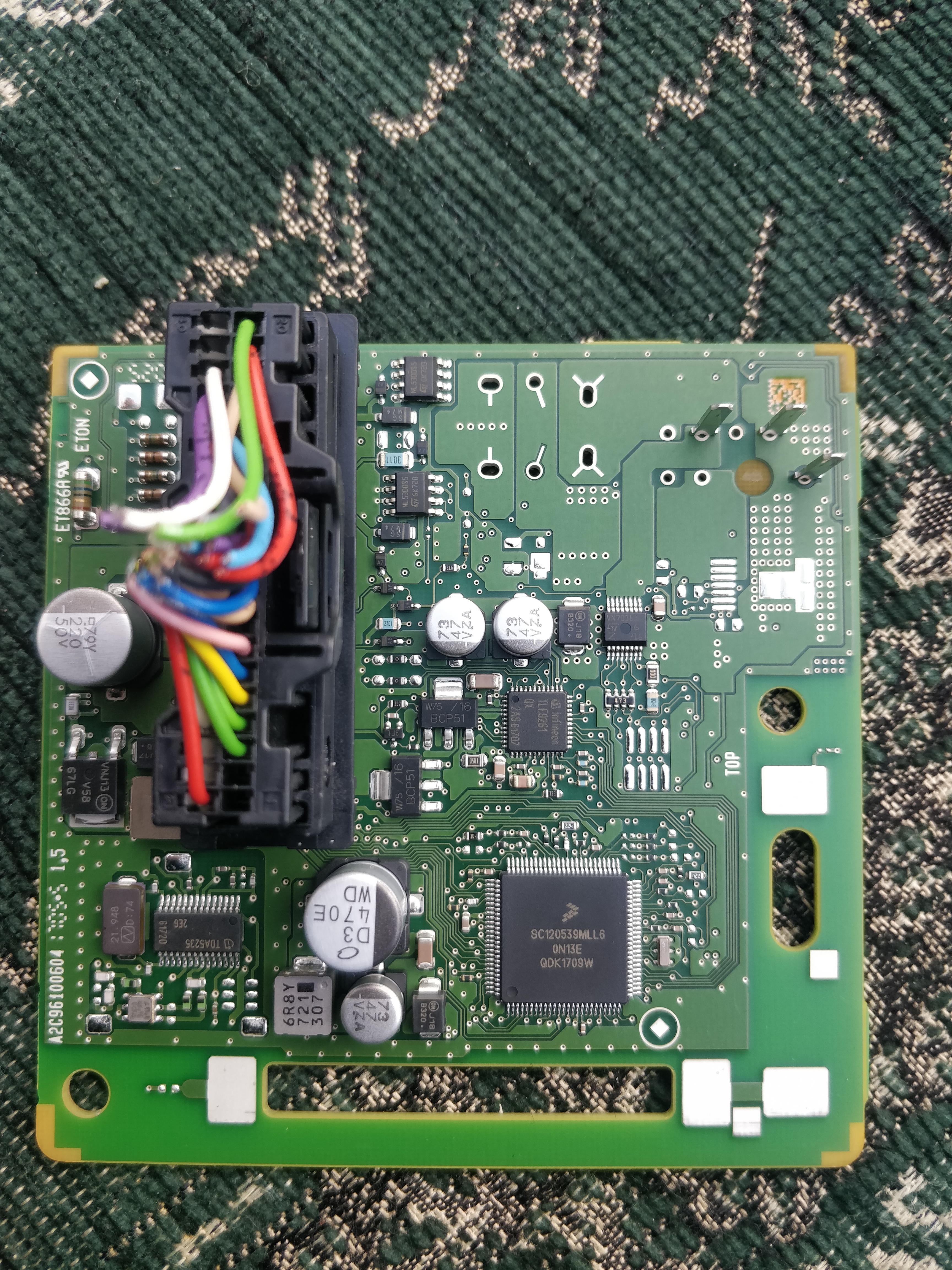 The Nissan Hands-Free Module ECU with the SPC5606B chip in chip-lockout configuration, used as the real-world target for the censorship-disable EMFI attack. Figure from Van den Herrewegen, Adam (Disabling Censorship on SPC5606B Chips).